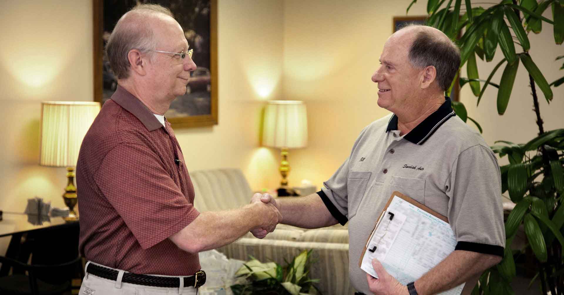 Bill Signs owner of Tokyo Town - Swedish Auto shaking hands with a customer